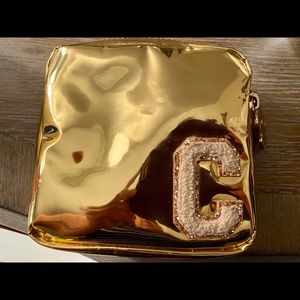 Limited edition gold mini pouch w/ a C